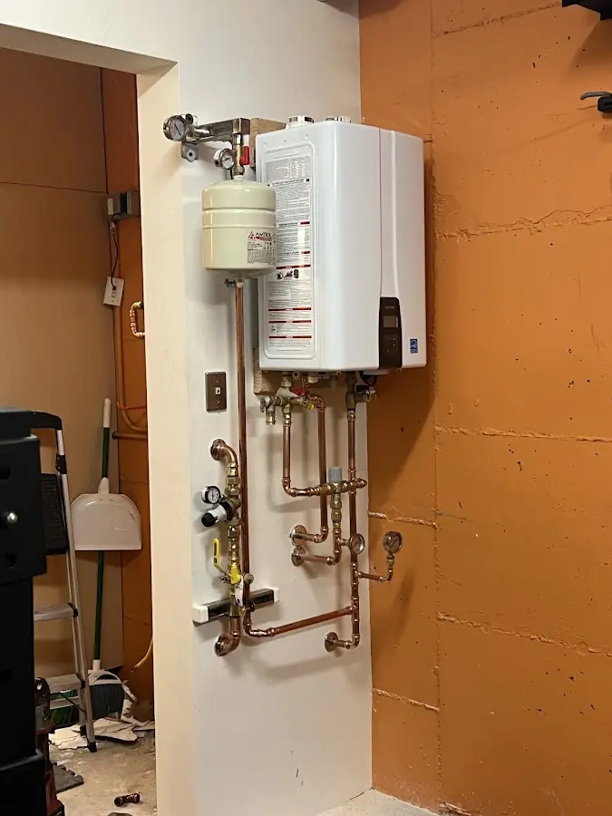 Plumbing technician inspecting water heater connections in Tarpon Springs